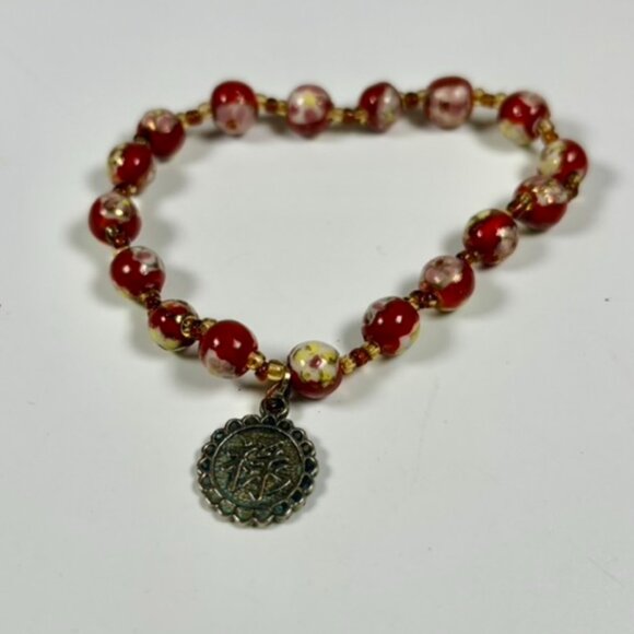 Stretch painted bead bracelet with a charm - Picture 1 of 4